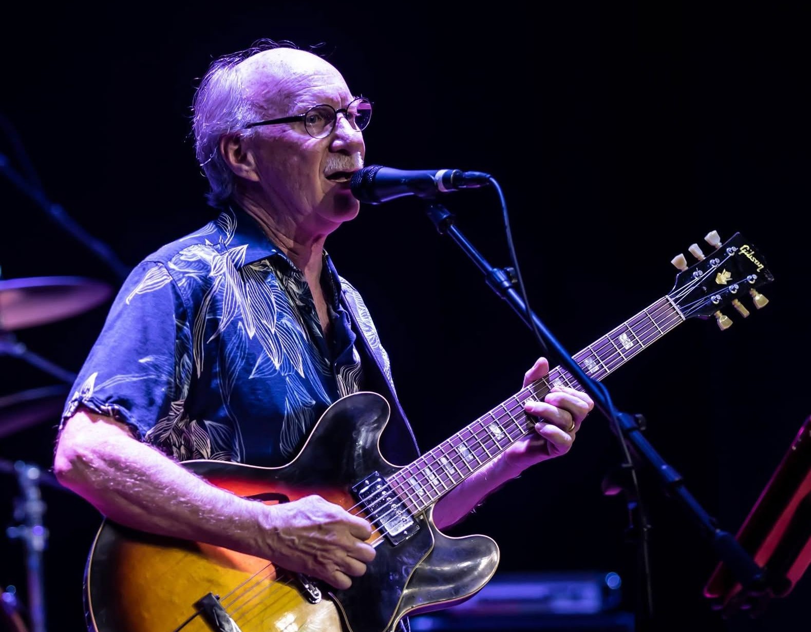 John Weyl singing and playing guitar.