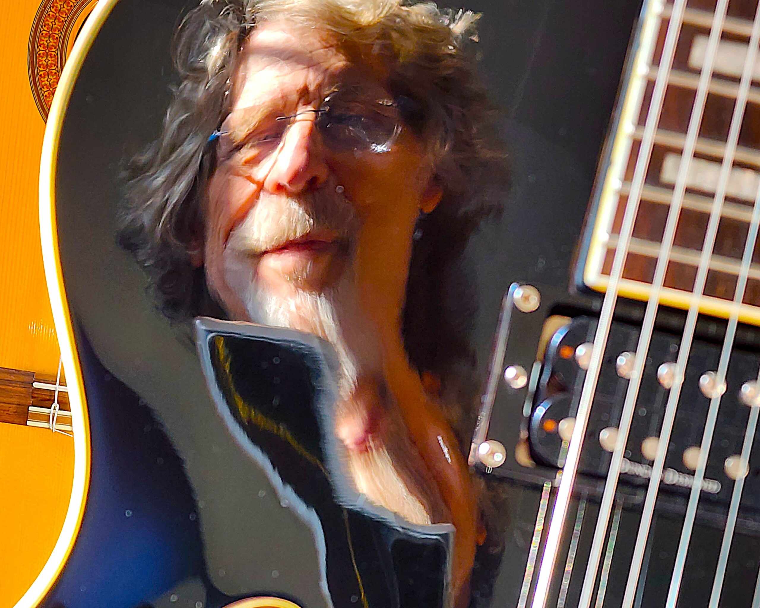 Chris Hickey and Friends Chris Hickey's reflection in a guitar