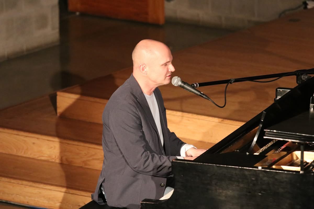 Levi Gangi singing and playing a piano