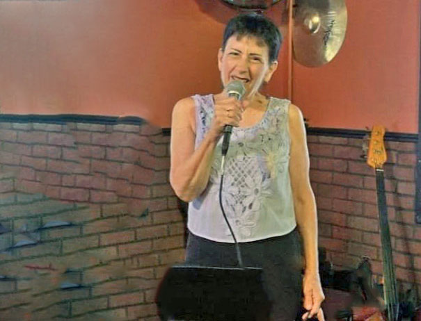 Mary DeFranco singing into a mic