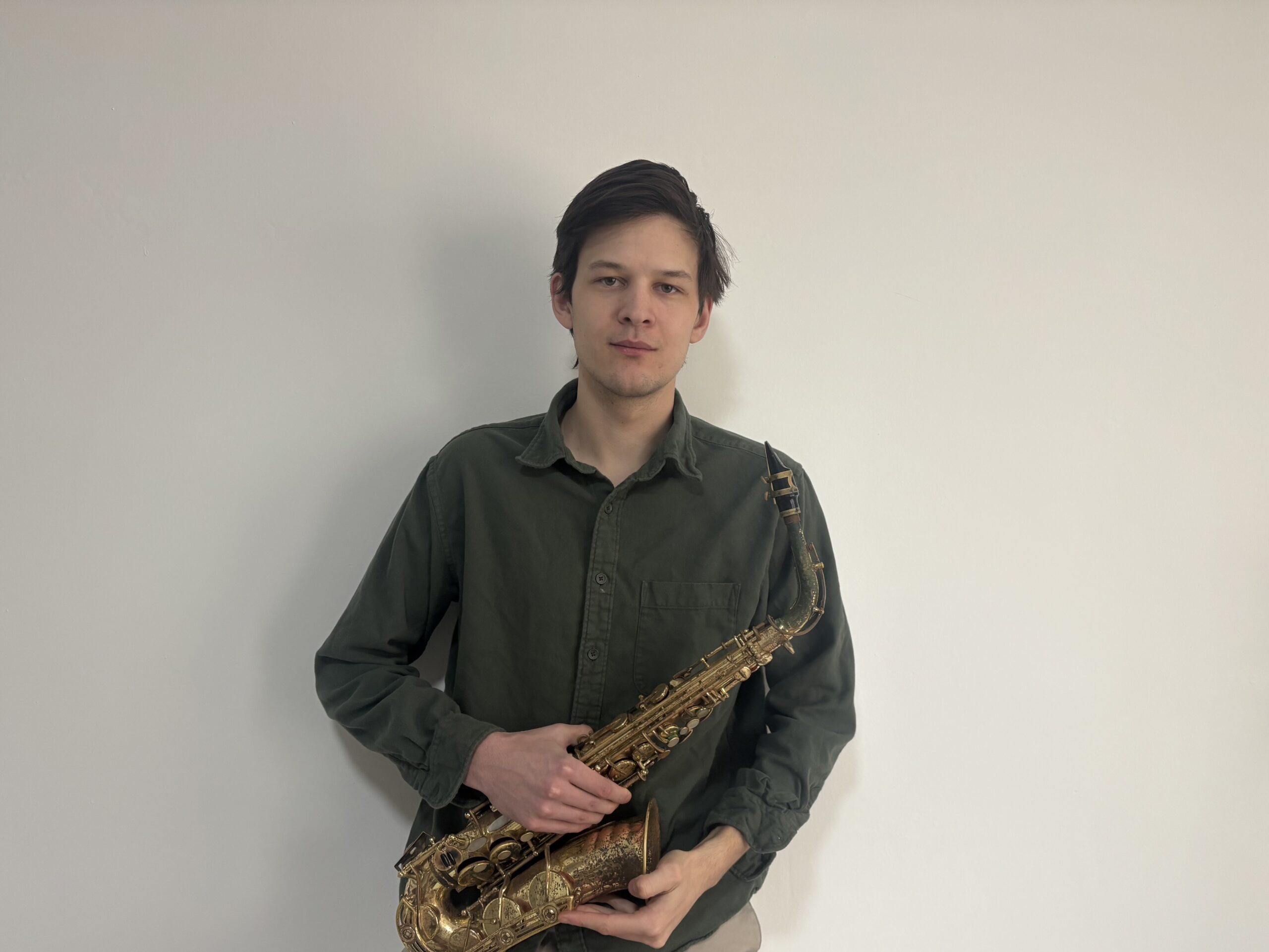 A man holding a saxophone.