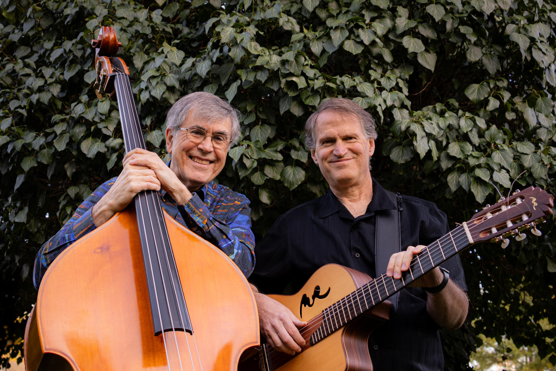 Dave Wright and Jon Randall Dave Wright and Jon Randall holding a cello and guitar