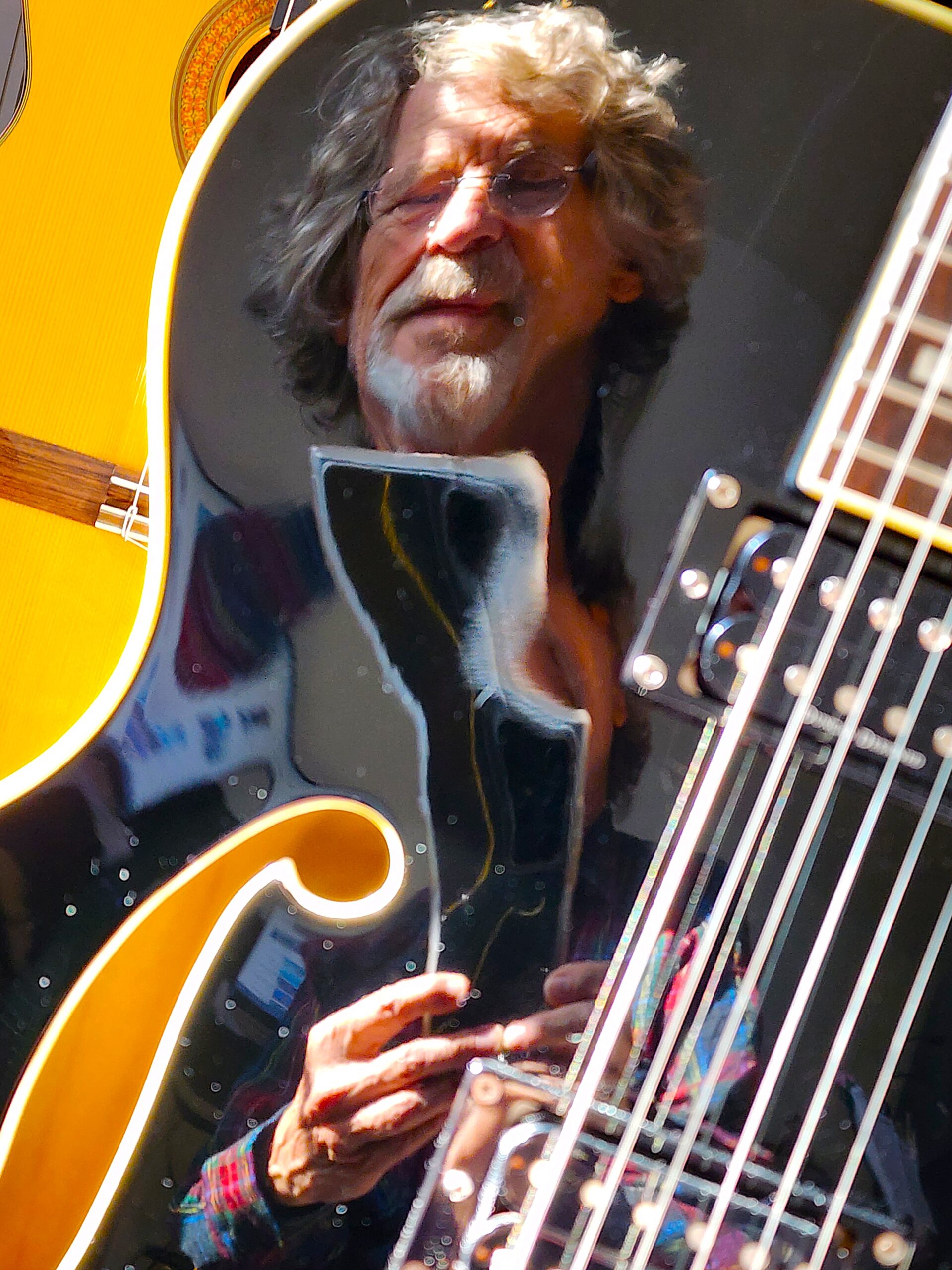 Chris Hickey and Friends Chris Hickey's reflection in a guitar