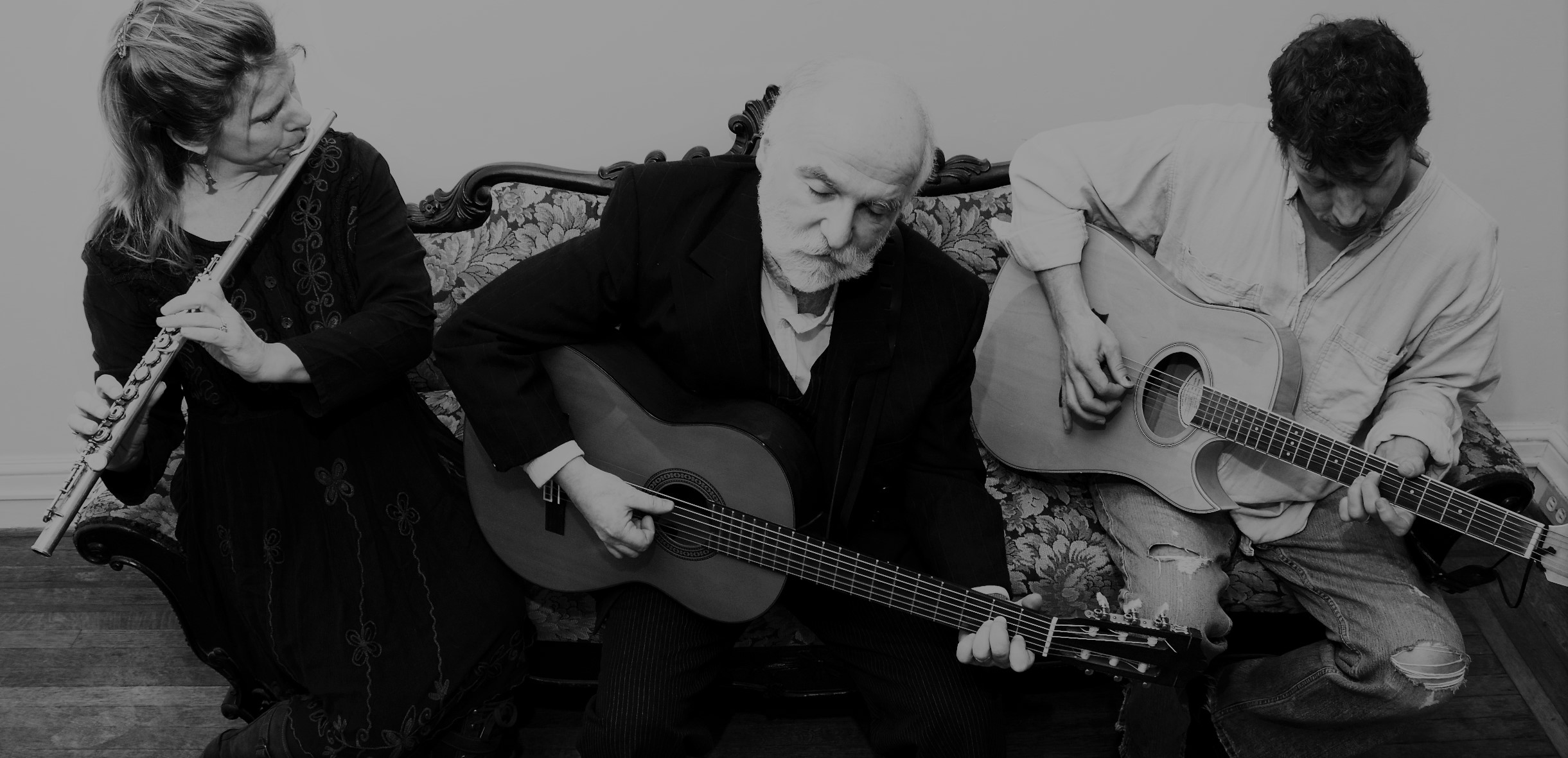 A black & white image of John Terlazzo playing guitar